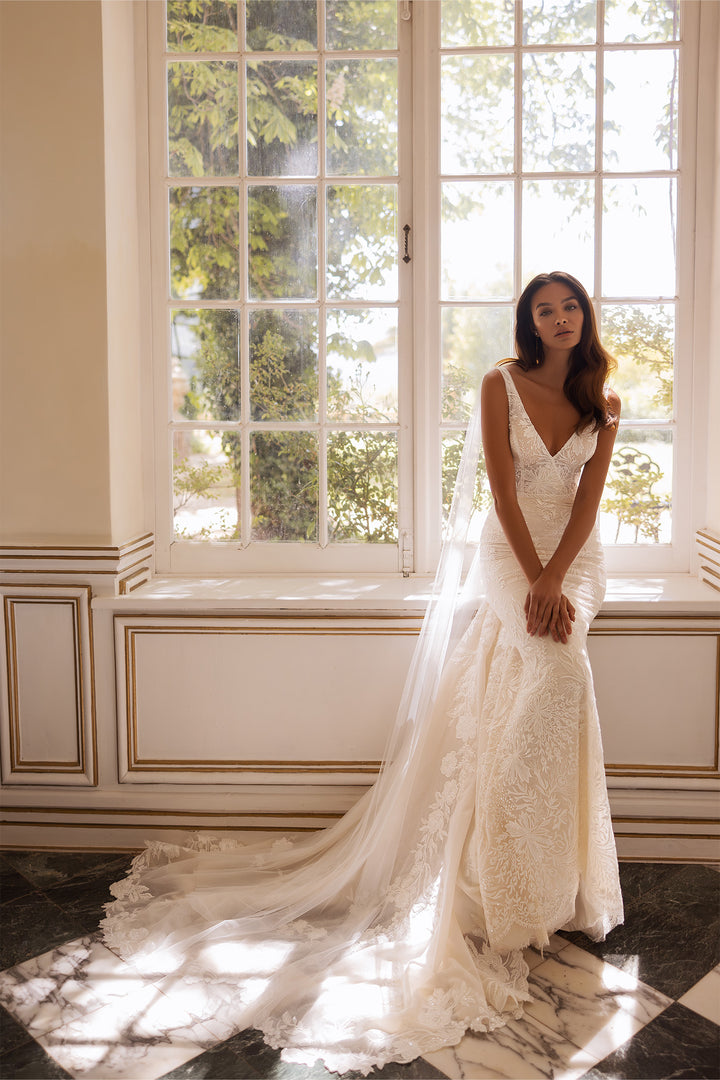 Bruna by Elly Bride | All-over Lace Mermaid Wedding Dress, Court train, Front View - Bride Sitting On Window Sil | The Laid Back Bride
