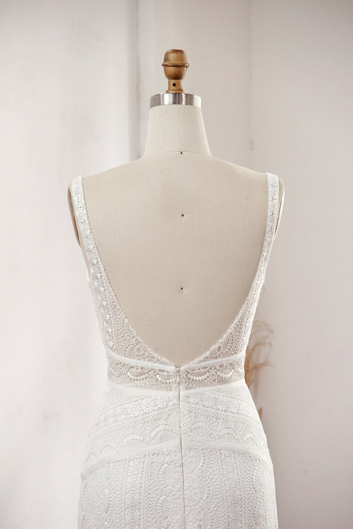 Modern column lace wedding dress close up of the back on a mannequin.