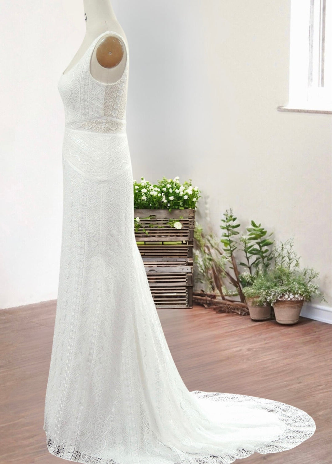 Modern column lace wedding dress with train on a mannequin.