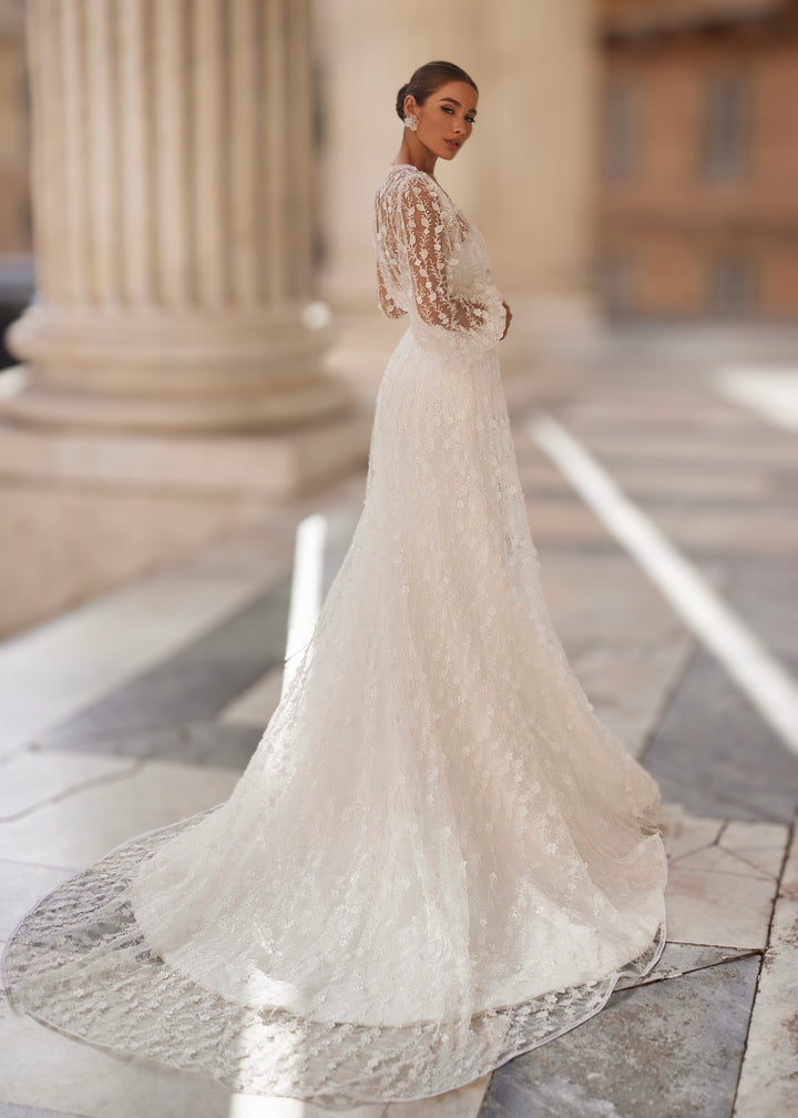 Woman in a strapless satin mermaid wedding dress with a sheer botanical robe with sleeves and a train.