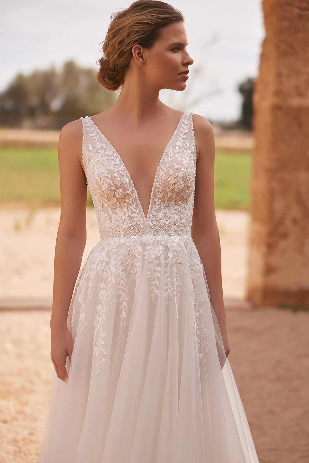 Harper by Elly Bride | Plunge v-neckline, Botanical lace detailing trailing down the waistline, Up Close Front View | The Laid Back Bride